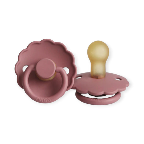 Two pink baby pacifiers on a white background