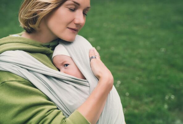 peaceful mother with baby sling